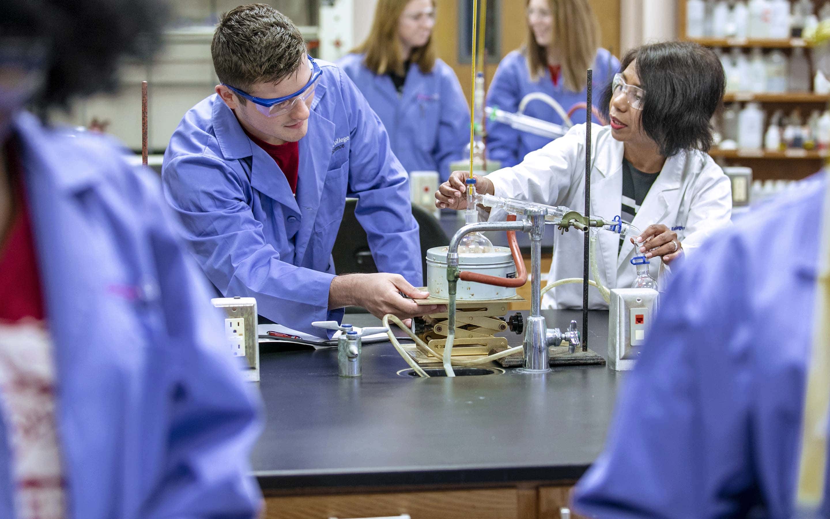 Manjula Koralegedara, professor of chemistry, with MC students.